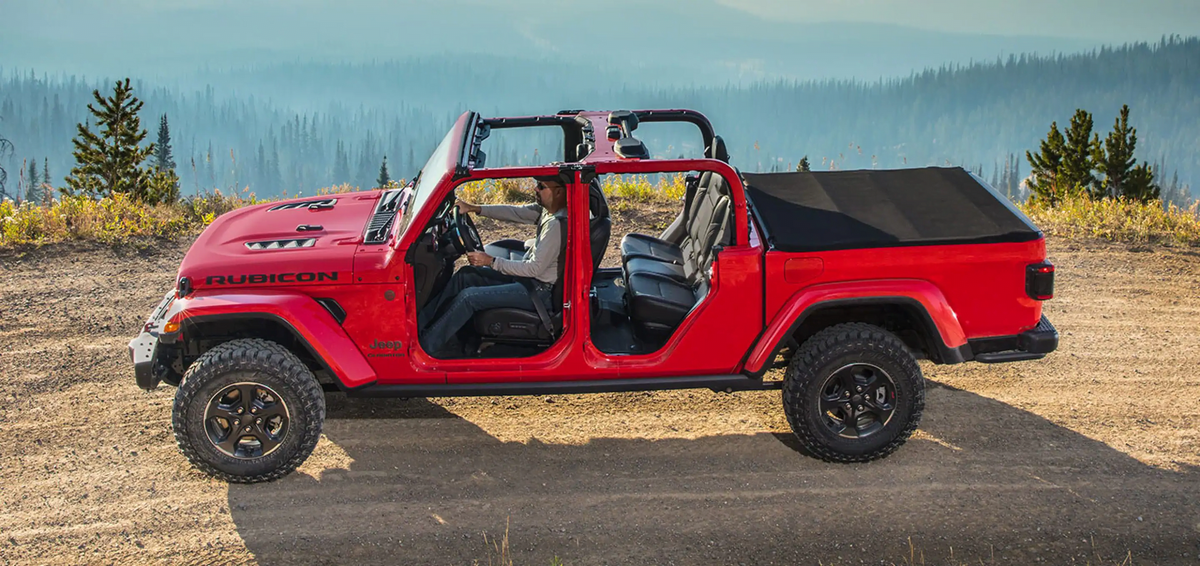 Red 2023 Jeep Gladiator with the roof off.
